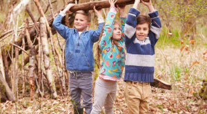 Three children prepare to make camp in the woods